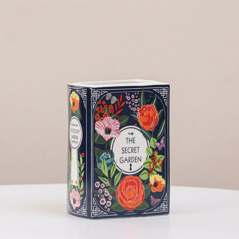 Vase céramique forme livre motif fleurs